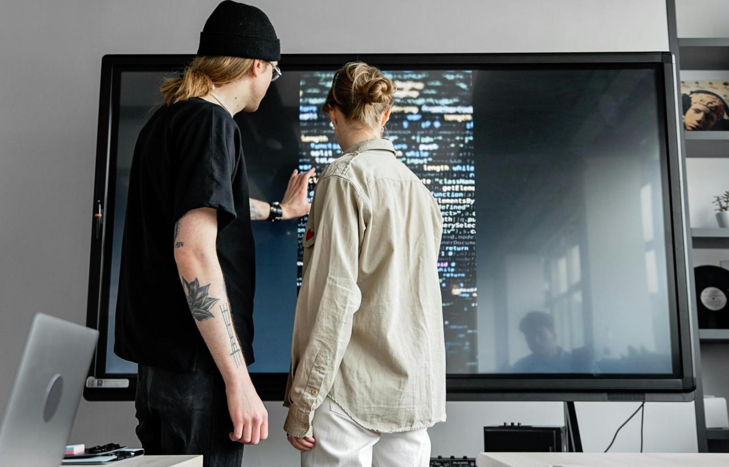 Team collaboration session reviewing mobile responsive layouts